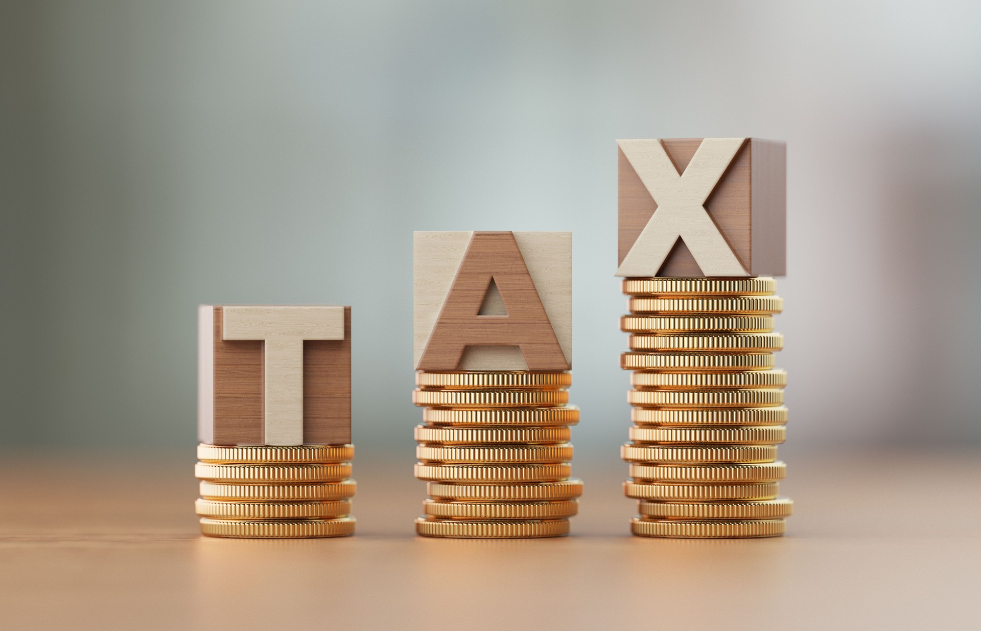 Cube Blocks And Coins Forming Tax Text Over Defocused Background